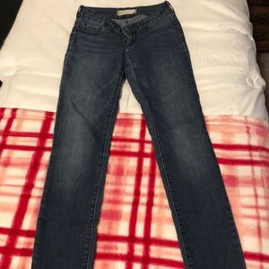 A pair of dark washed jeans